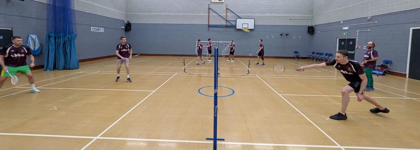 Badders Mafia players in the new kit playing doubles, with more games on the courts behind